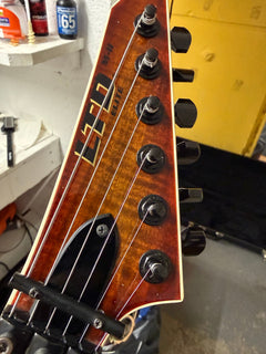 LTD electric guitar with a Floyd Rose tremolo on the repair bench