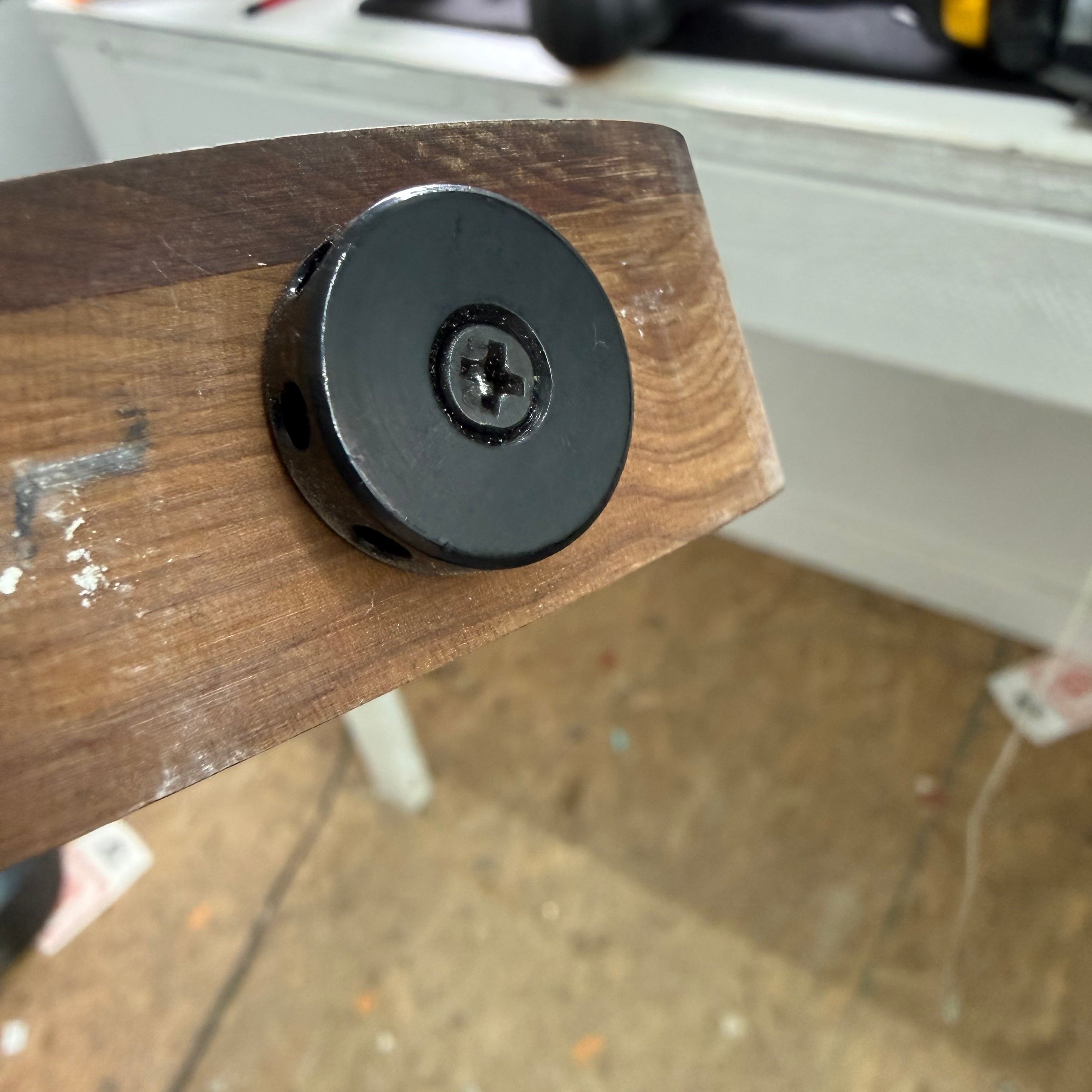 Barrel-style truss rod nut on a Sterling StingRay Ray34 roasted maple neck at the repair bench