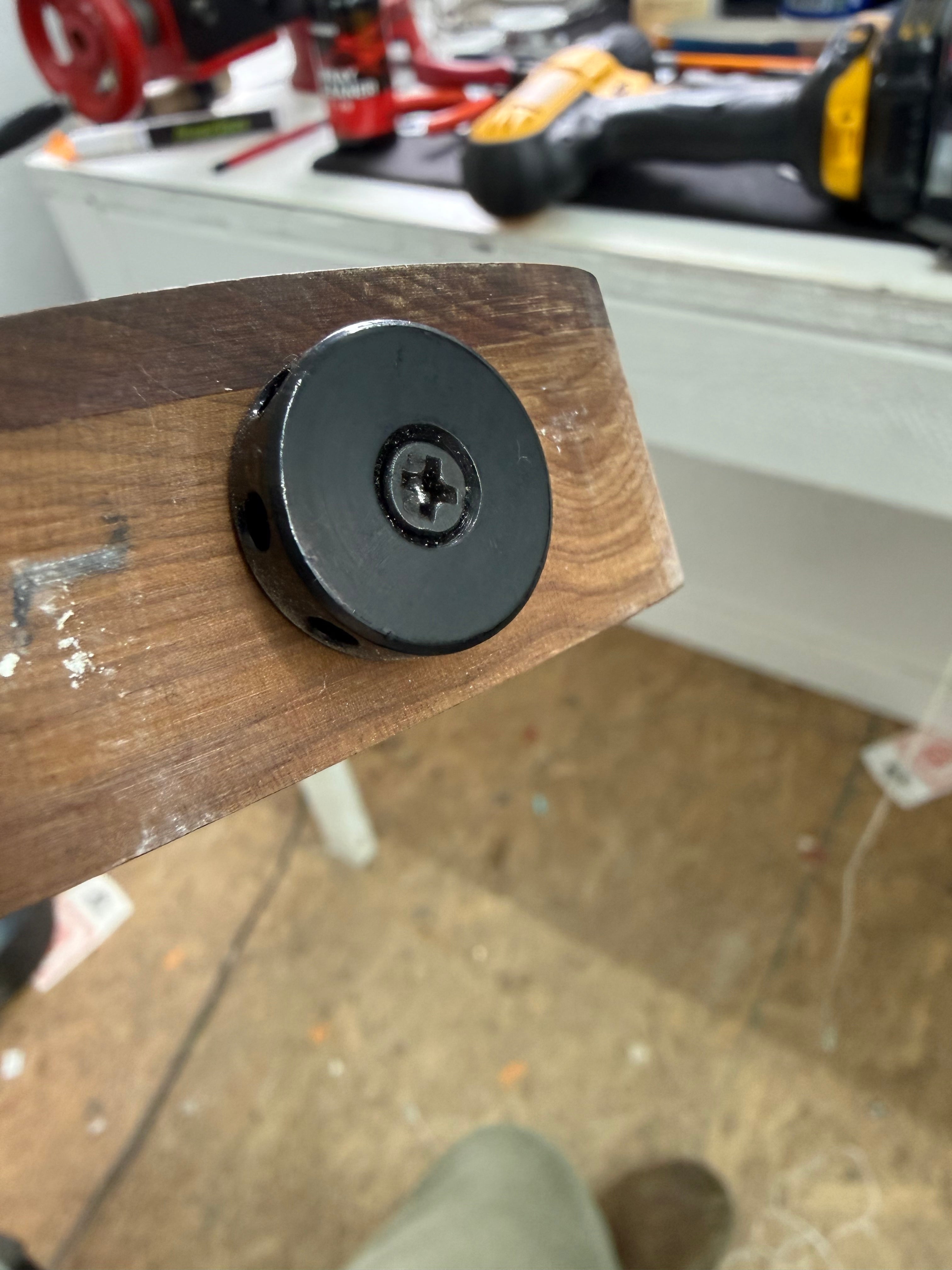 Barrel-style truss rod nut on a Sterling StingRay Ray34 roasted maple neck at the repair bench