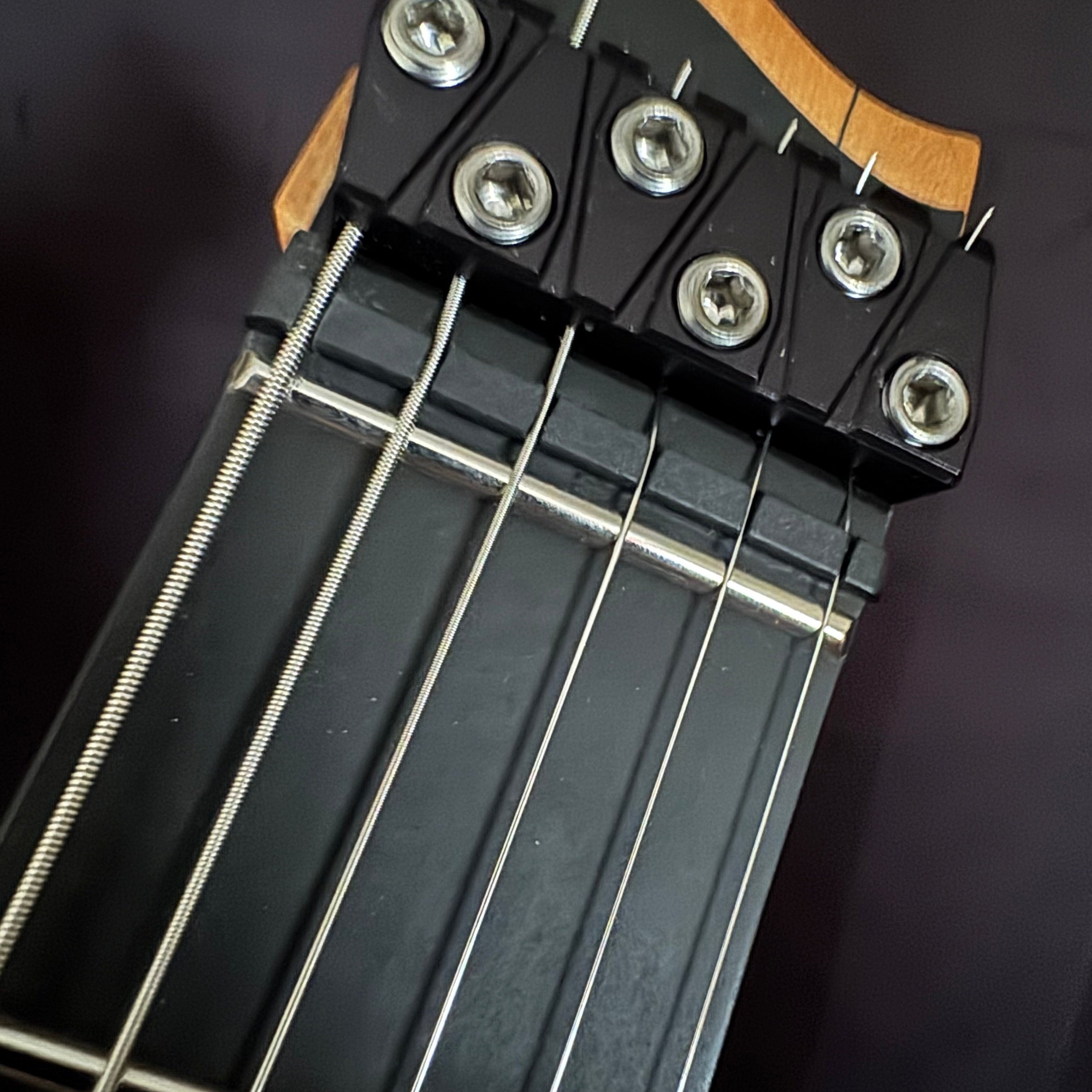 Headless end of a Strandberg Boden Prog NX showing the nut and string termination block at the repair bench at Paul's Guitar Hideout