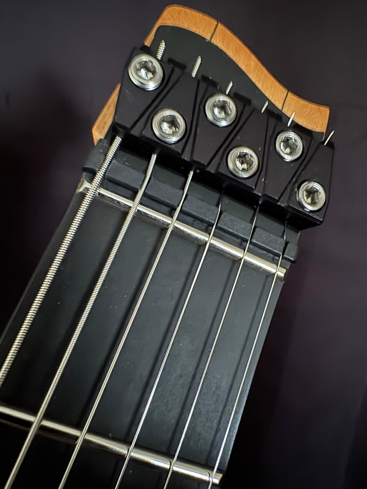 Headless end of a Strandberg Boden Prog NX showing the nut and string termination block at the repair bench at Paul's Guitar Hideout