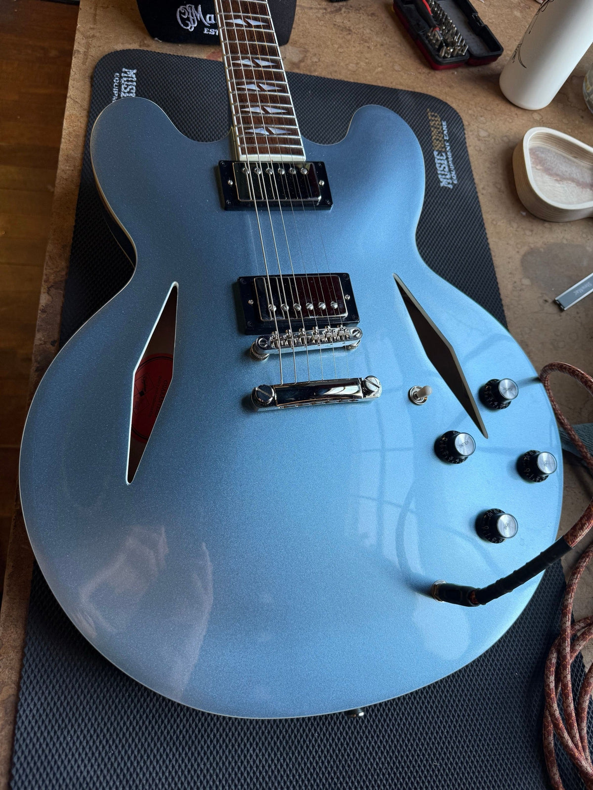 Epiphone DG-335 in Pelham Blue on the repair bench after a setup for 10s