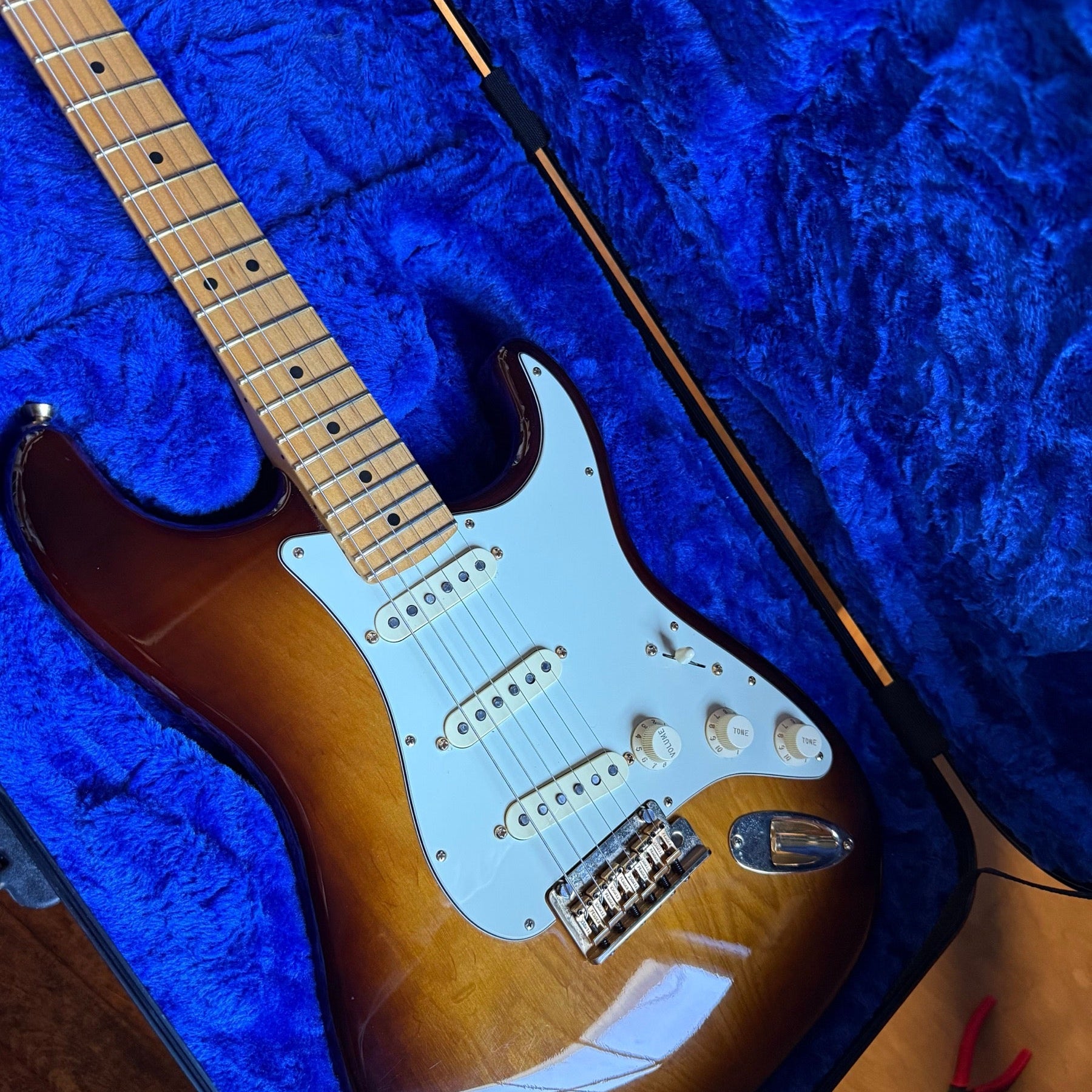 Fender 75th Anniversary Stratocaster in two-color sunburst in its case on the repair bench