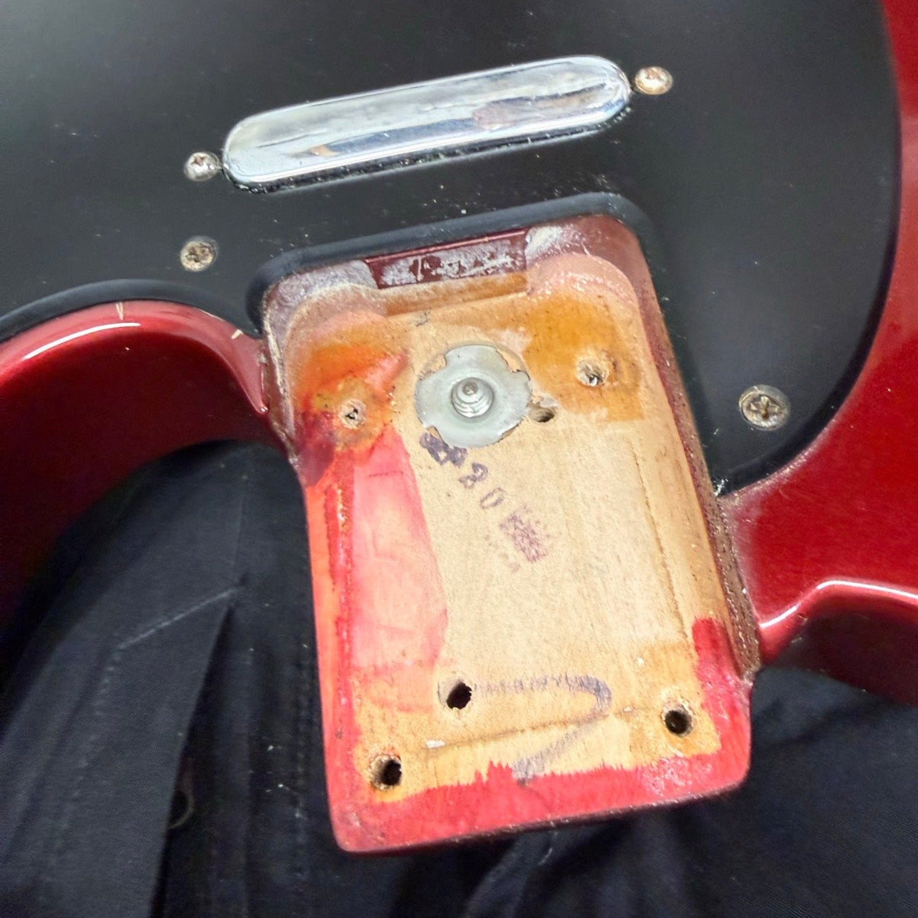 Neck pocket of a red Fender USA Telecaster with the neck removed, on the repair bench