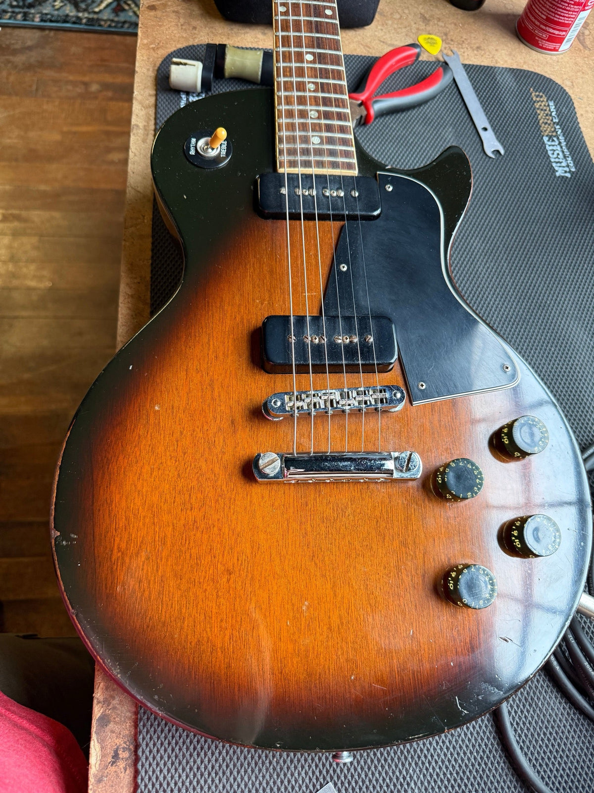 Sunburst Gibson Les Paul with P-90 pickups on the repair bench