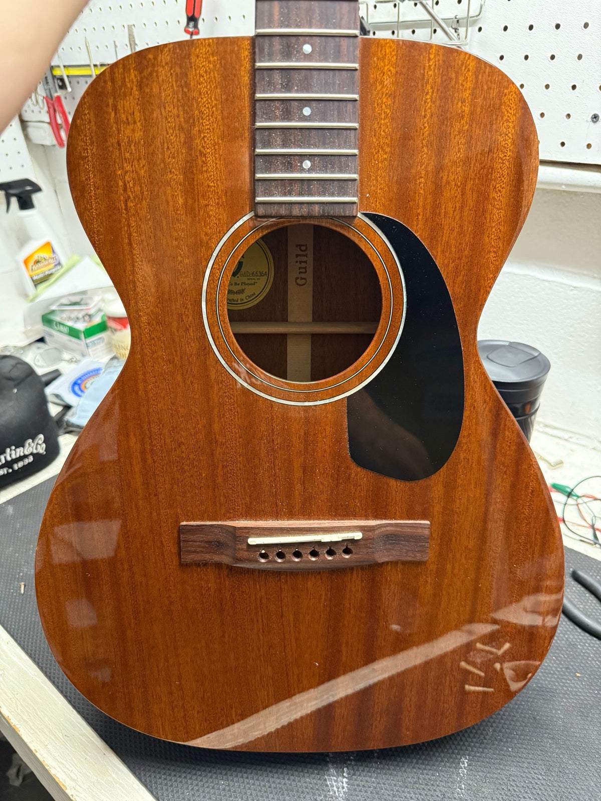 All-mahogany Guild acoustic guitar on the repair bench