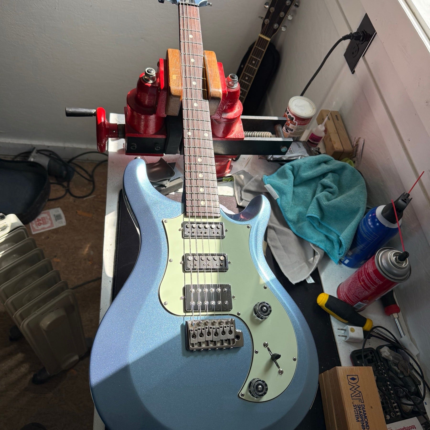 PRS S2 Studio in Frost Blue Metallic with a mint pickguard on the repair bench