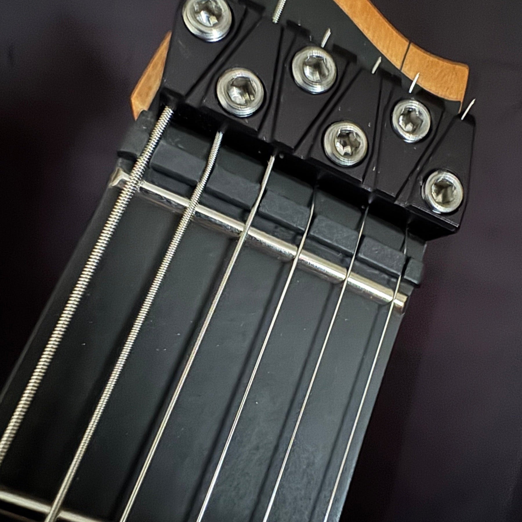 Headless end of a Strandberg Boden Prog NX showing the nut and string clamps on the repair bench