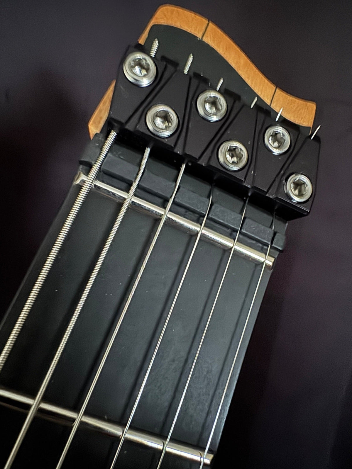 Headless end of a Strandberg Boden Prog NX showing the nut and string clamps on the repair bench