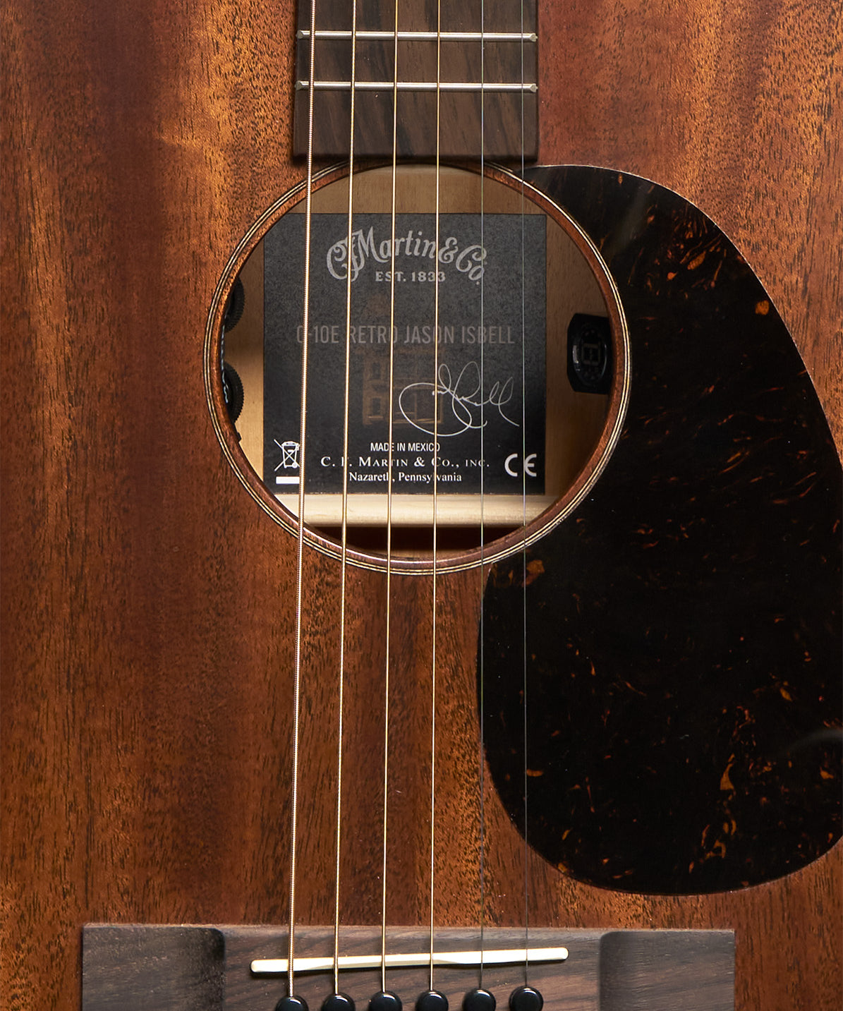 Martin 0-10E Retro Jason Isbell body at three-quarter angle with faux tortoise pickguard
