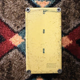 MXR Distortion+, yellow: bottom plate with the embossed MXR logo, four screws and dark marks