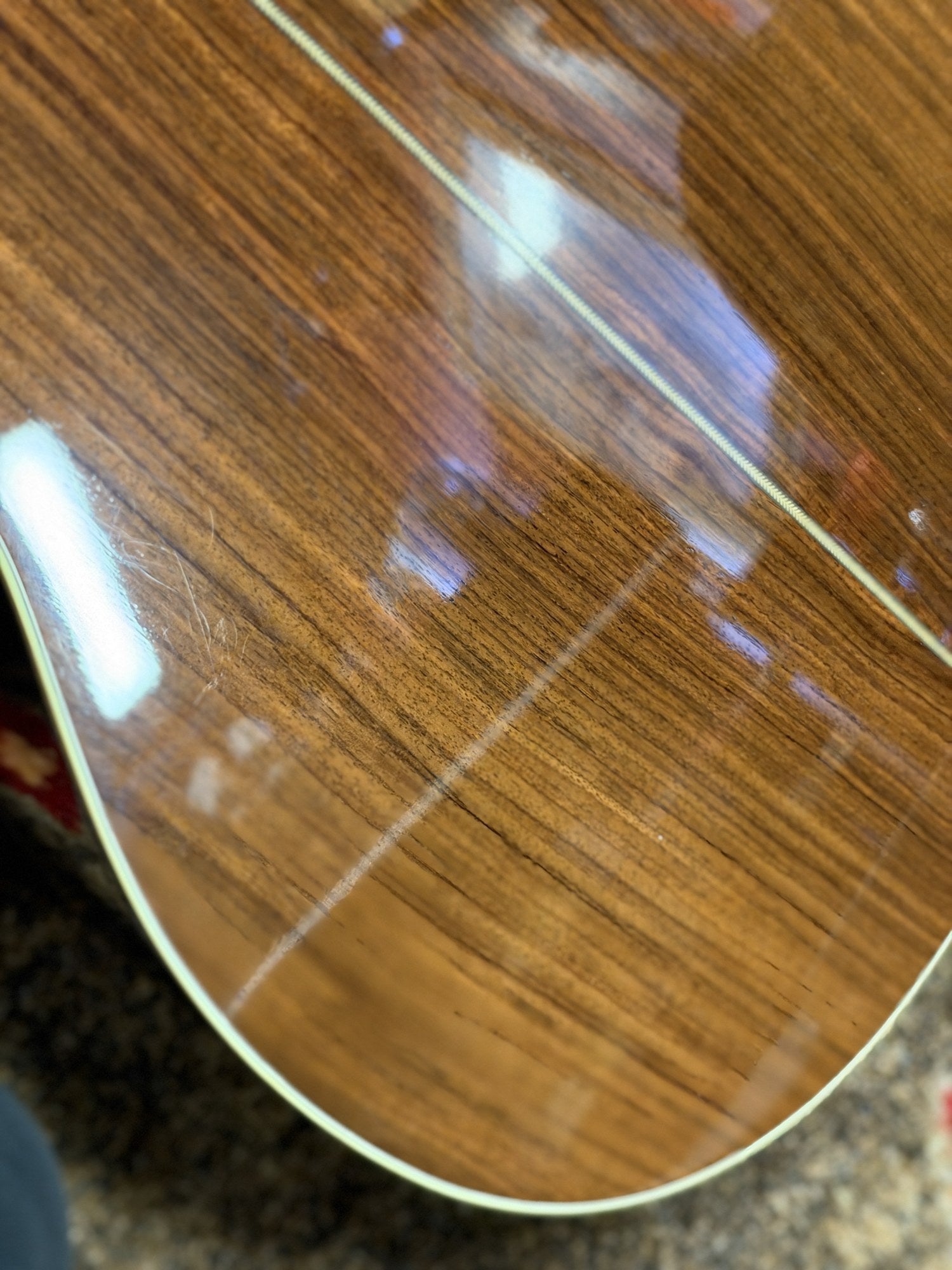 Martin 000C-28SMH Merle Haggard Blue Yodel No. 13, 2001: lower back edge and binding, light marks under glare