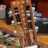 Martin 000C-28SMH Merle Haggard Blue Yodel No. 13, 2001: headstock face and nut, Blue Yodel No. 13 inlay, shop background