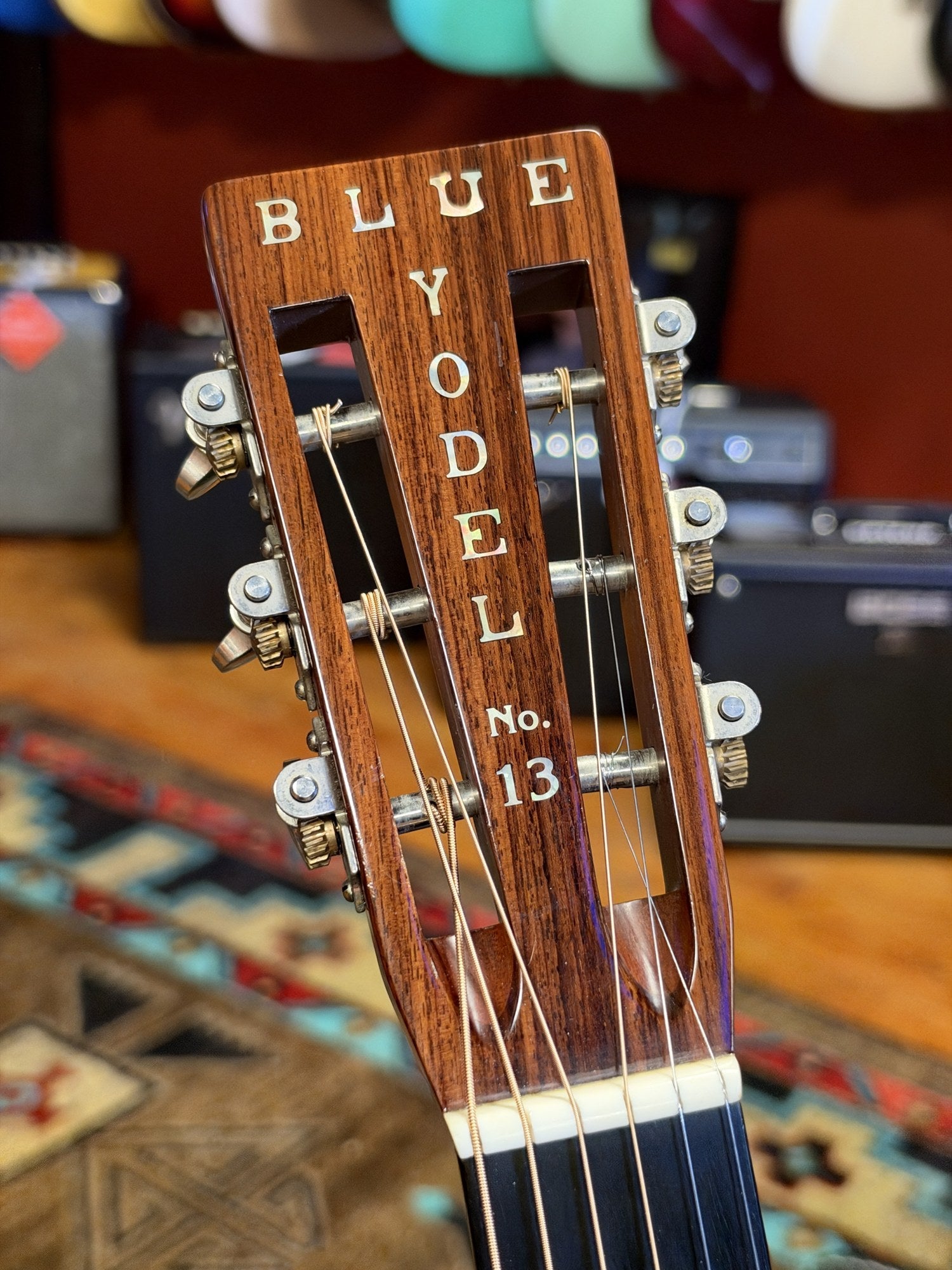 Martin 000C-28SMH Merle Haggard Blue Yodel No. 13, 2001: headstock face and nut, Blue Yodel No. 13 inlay, shop background