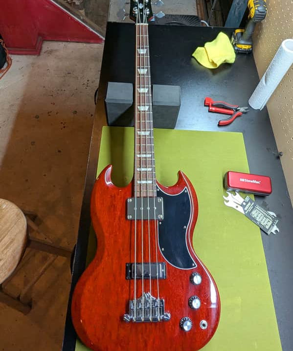 2019 Gibson SG Standard Bass - front full body on workbench - Pauls Guitar Hideout