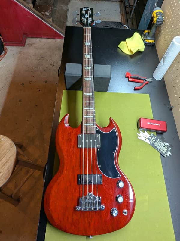 2019 Gibson SG Standard Bass - front full body on workbench - Pauls Guitar Hideout