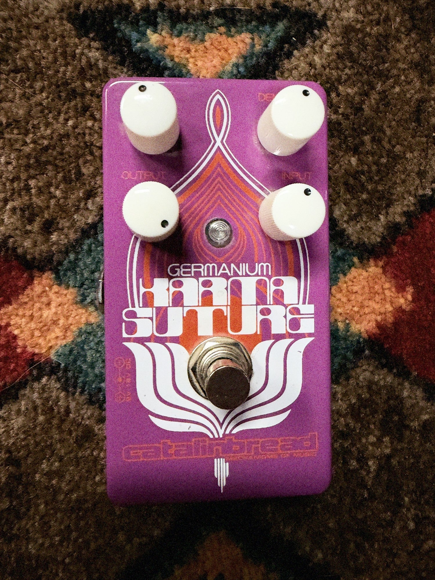 Catalinbread Karma Suture Germanium, purple: top with the four white knobs, the Germanium Karma Suture artwork, the LED and the footswitch
