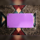 Catalinbread Karma Suture Germanium, purple: bottom plate with four screws and a small scuff near one edge