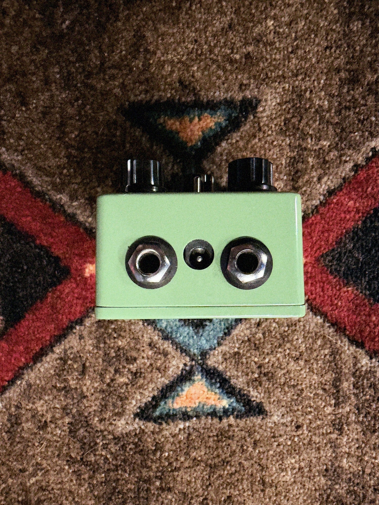 EarthQuaker Devices Plumes, green: knob end with two 1/4 inch jacks and the power jack between them