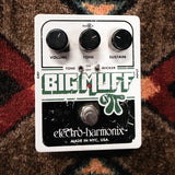 Electro-Harmonix Big Muff Pi with Tone Wicker, white: top with the Volume, Tone and Sustain knobs, the Tone and Wicker switches and the footswitch, with scratches and chips in the green and black print