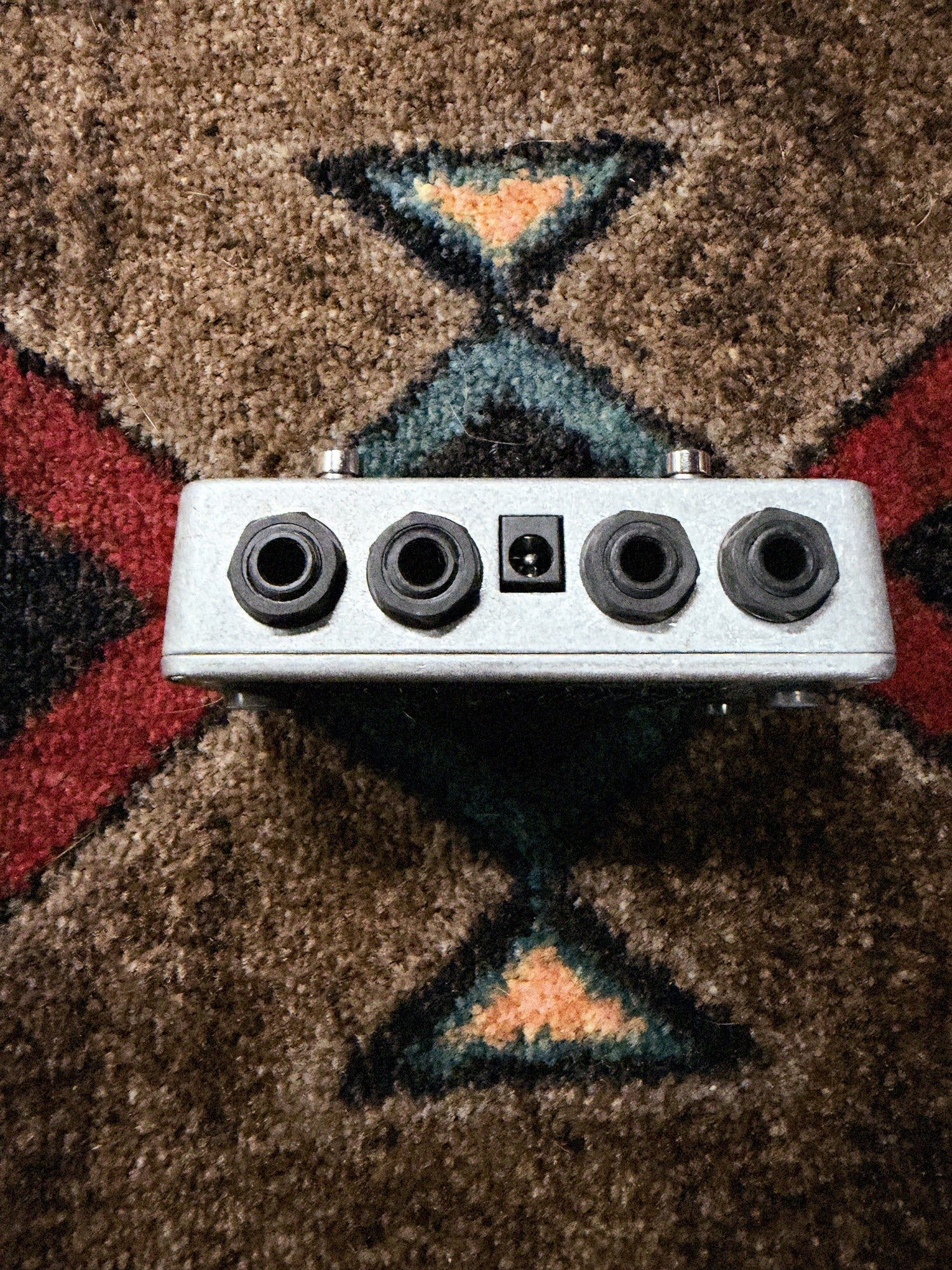 Electro-Harmonix Switchblade Plus, black and blue: top end with the Input, Tuner, Out A and Out B jacks and the power jack