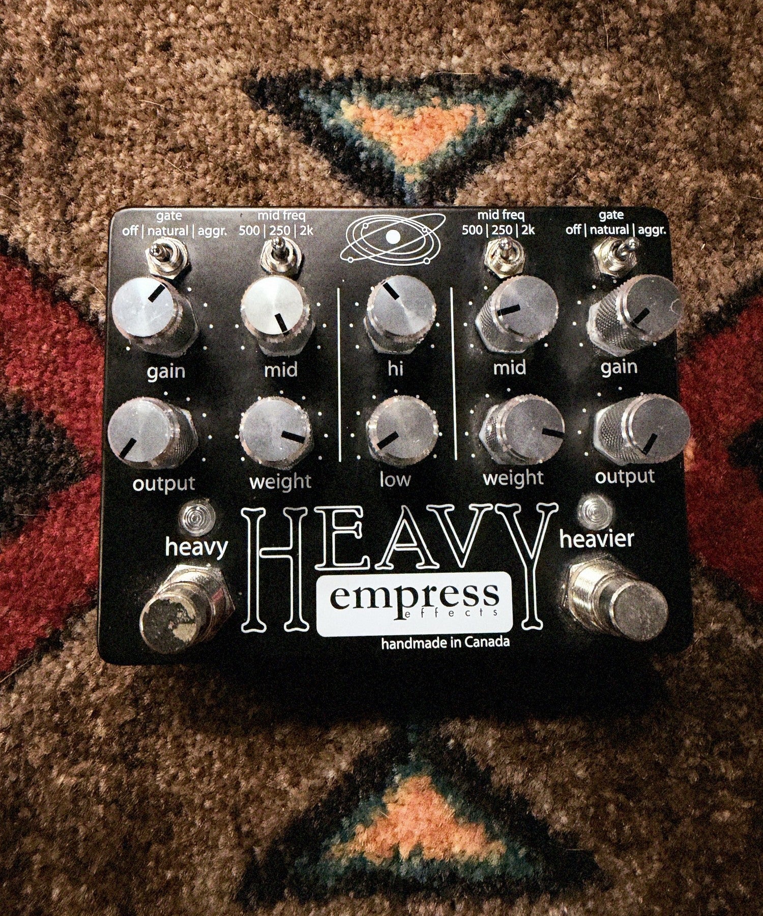 Empress Effects Heavy, black: top with the ten knobs, the gate and mid freq switches, the heavy and heavier footswitches and dark marks on the heavy footswitch cap