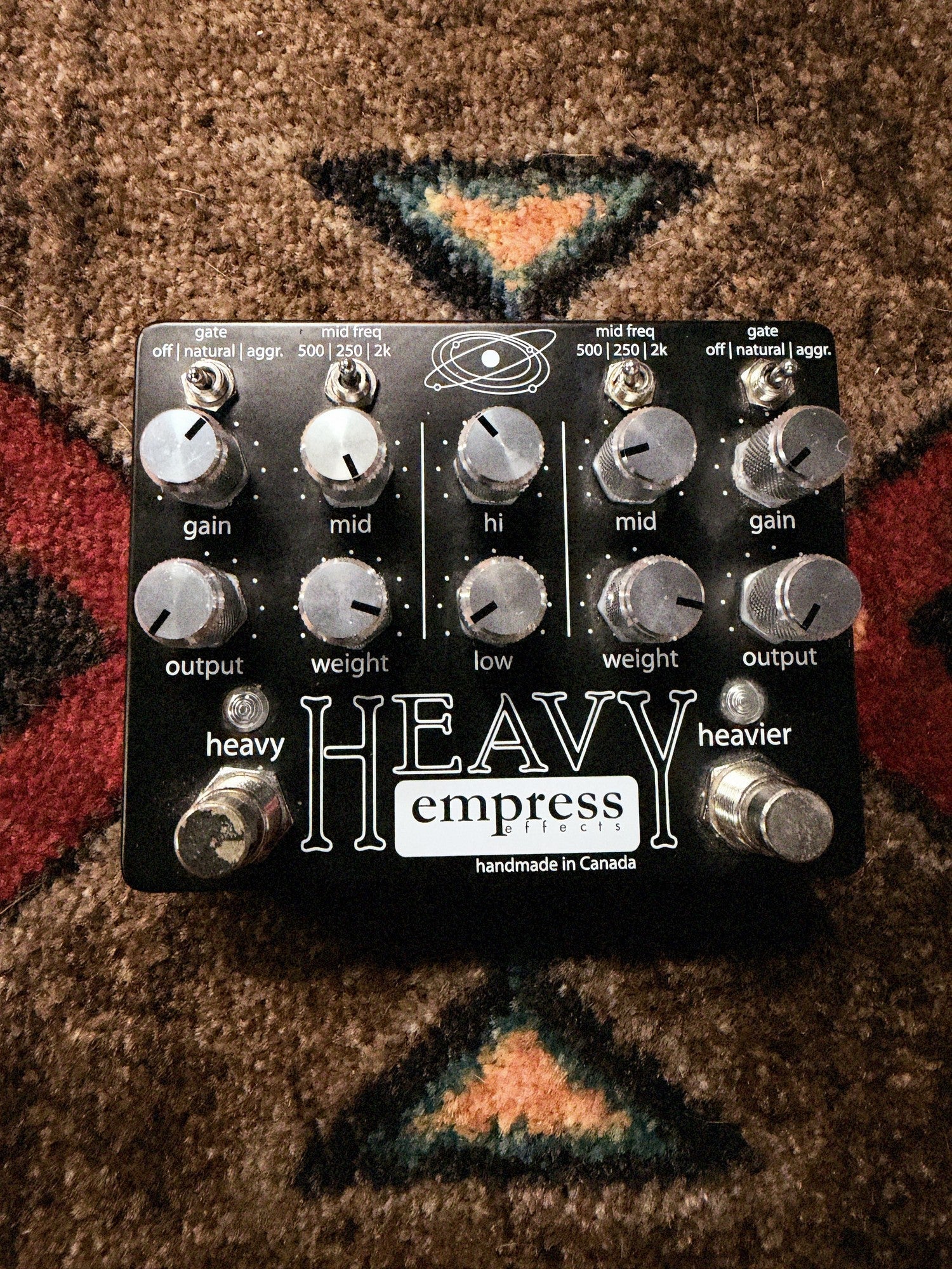 Empress Effects Heavy, black: top with the ten knobs, the gate and mid freq switches, the heavy and heavier footswitches and dark marks on the heavy footswitch cap