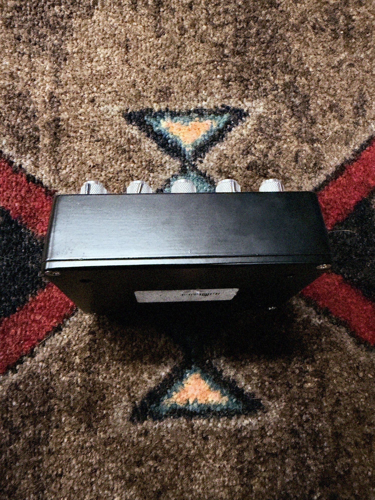 Empress Effects Heavy, black: back side of the enclosure below the knob row, with part of the bottom plate