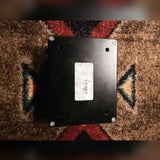 Empress Effects Heavy, black: bottom plate with four screws, four holes and a worn barcode sticker