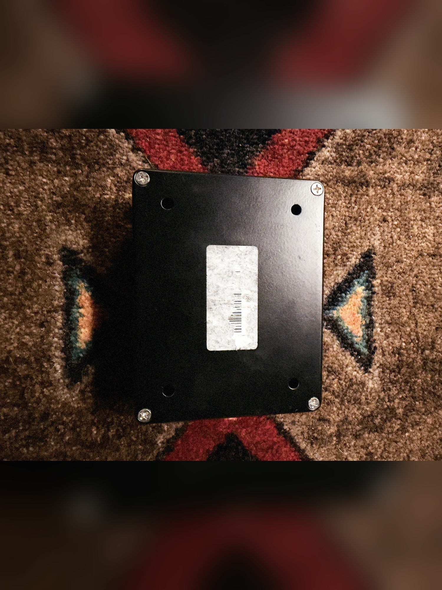Empress Effects Heavy, black: bottom plate with four screws, four holes and a worn barcode sticker