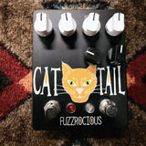 Fuzzrocious Cat Tail with 2nd Distortion Mod, black: top with the orange cat graphic, four white knobs, two black clipping knobs, two footswitches and the red and clear LEDs