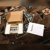 Hughes & Kettner AmpMan Classic, light gray: the amp in its open box between the foam blocks, with the manual beside it