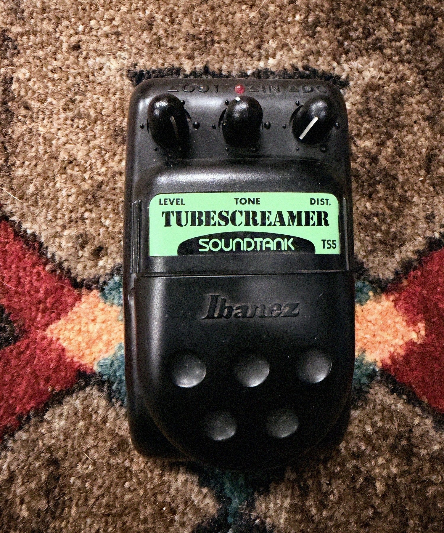 Ibanez Soundtank TS5 Tube Screamer, black: top with the Level, Tone and Dist. knobs, the LED, the green Tubescreamer Soundtank label and the Ibanez pedal