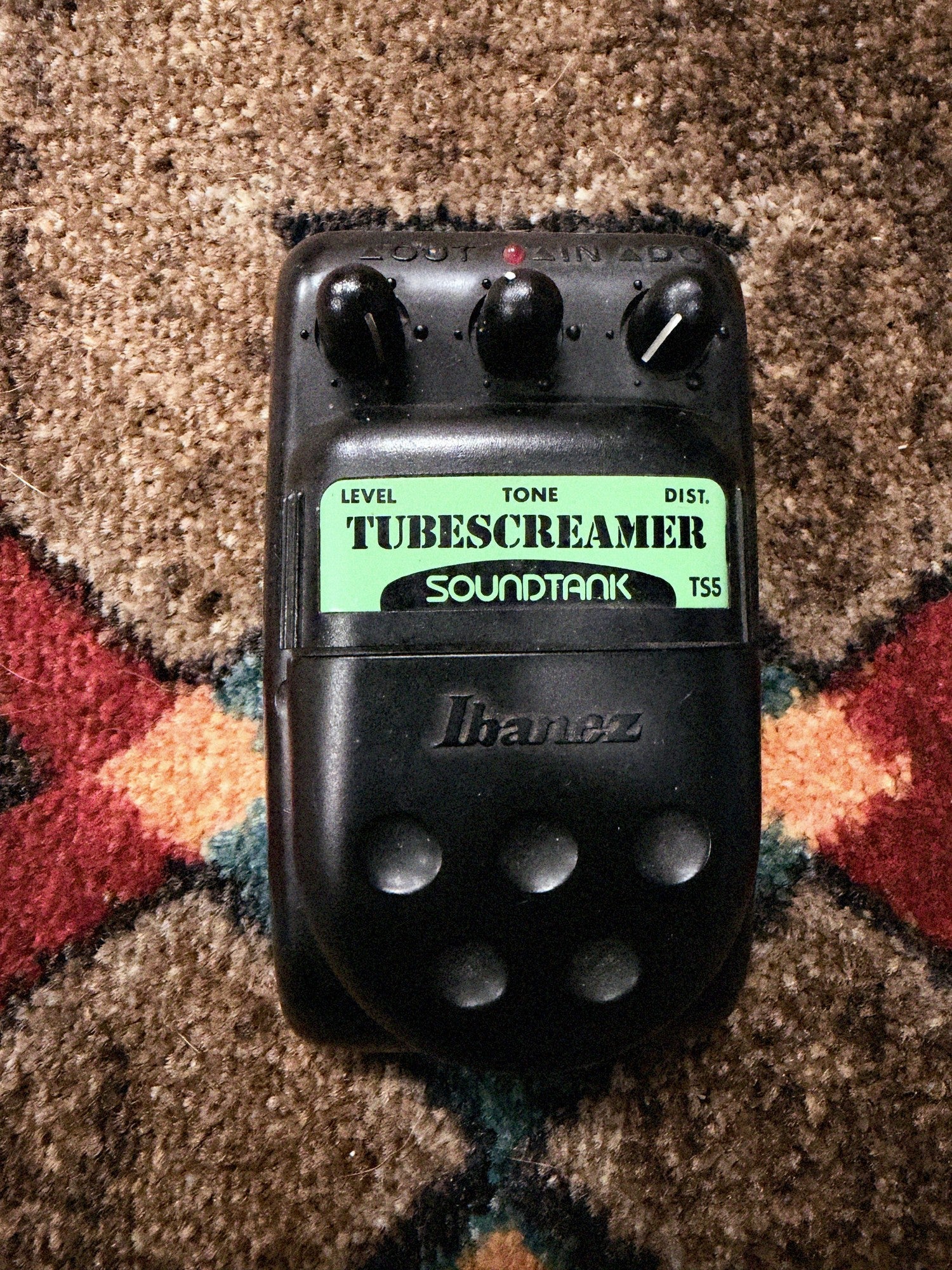 Ibanez Soundtank TS5 Tube Screamer, black: top with the Level, Tone and Dist. knobs, the LED, the green Tubescreamer Soundtank label and the Ibanez pedal