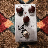 J. Rockett Audio Designs Archer, silver: top with the Output, Gain and Treble knobs, the LED, the archer drawing and the footswitch