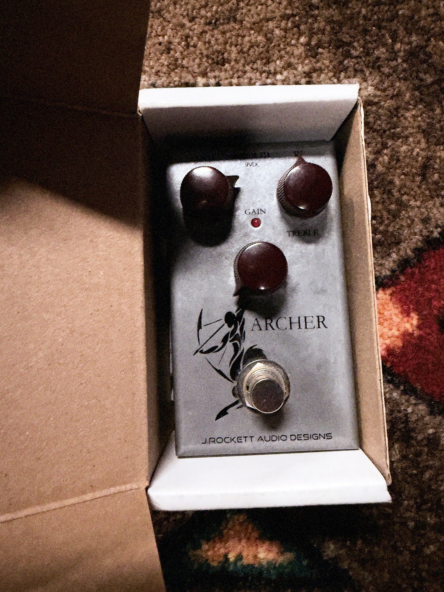 J. Rockett Audio Designs Archer, silver: the pedal sitting in its open J. Rockett box