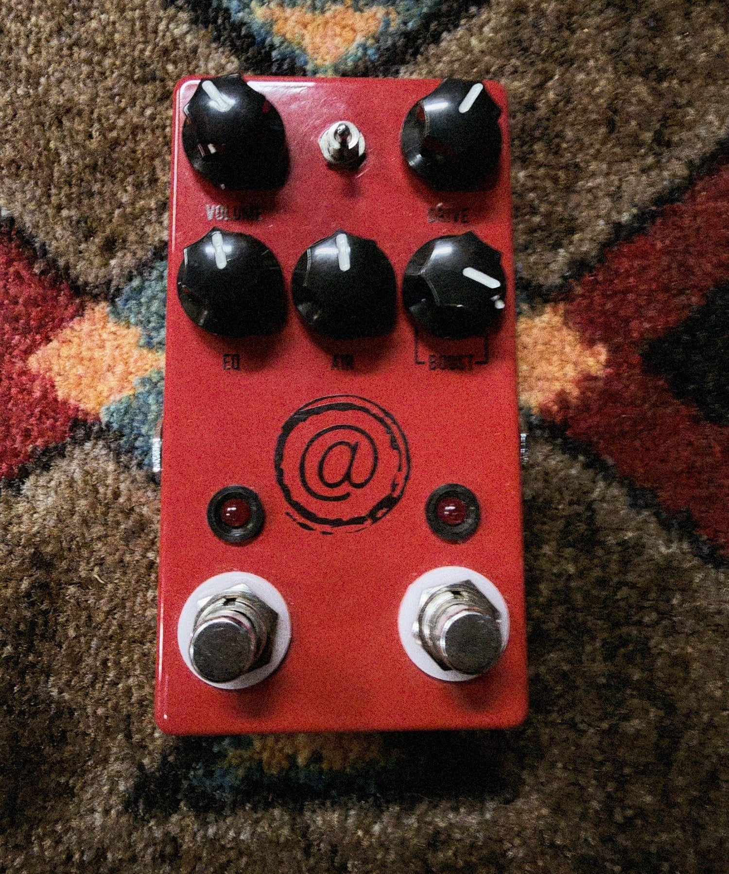 JHS AT+, red: top with the Volume, Drive, EQ, Air and Boost knobs, the three-way toggle, the @ logo and both footswitches