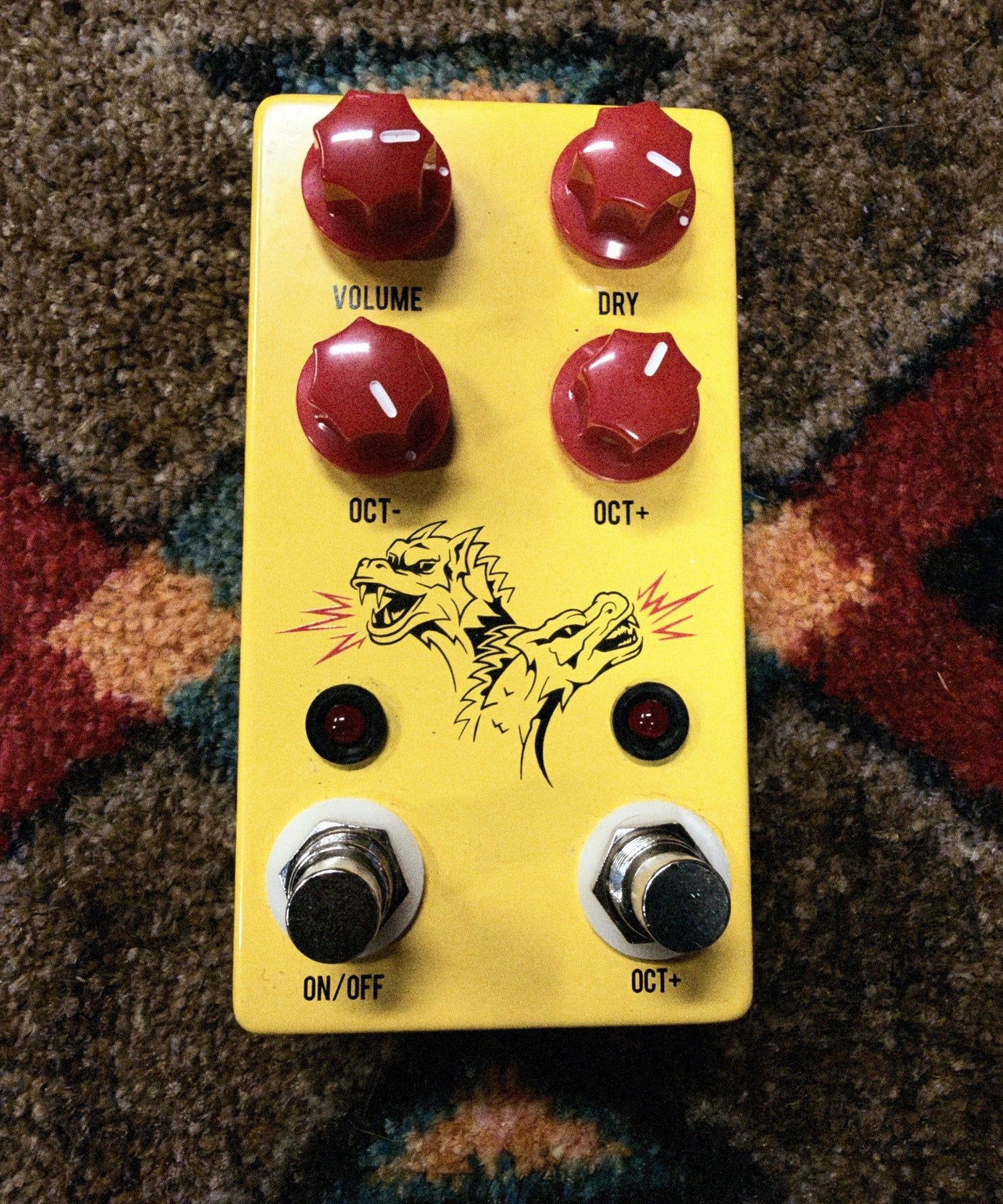 JHS Double Dragon Lo-Fi Octave Device, yellow: top with the Volume, Dry, Oct- and Oct+ knobs, the two-headed dragon art, two lights and the On/Off and Oct+ footswitches