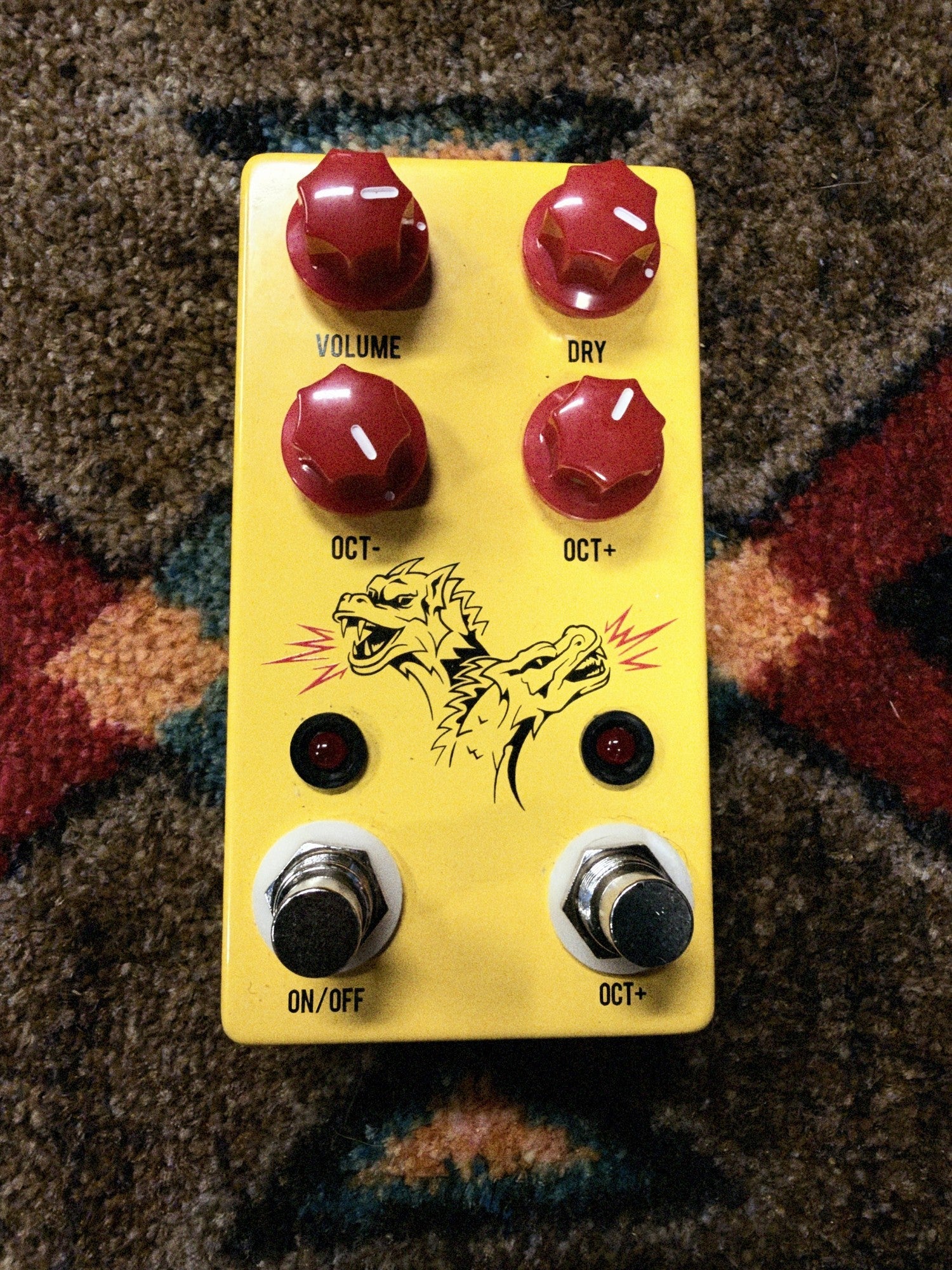 JHS Double Dragon Lo-Fi Octave Device, yellow: top with the Volume, Dry, Oct- and Oct+ knobs, the two-headed dragon art, two lights and the On/Off and Oct+ footswitches