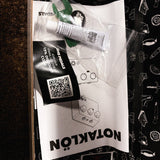 JHS Notaklön, white: the goop tube, green plastic wrench and instructions left from the kit