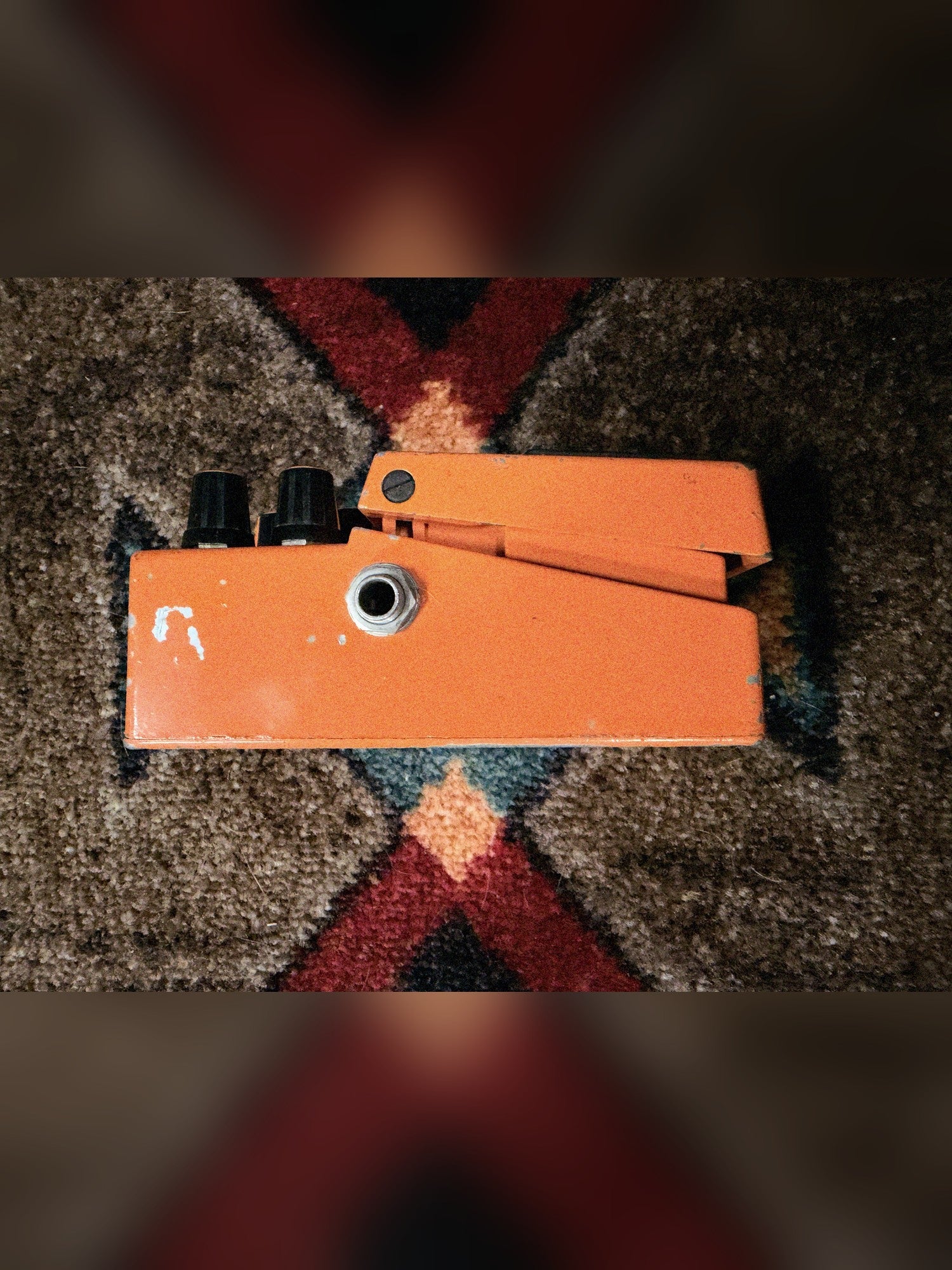 KMD Overdrive, orange: left side with the output jack and a paint chip near the knob end