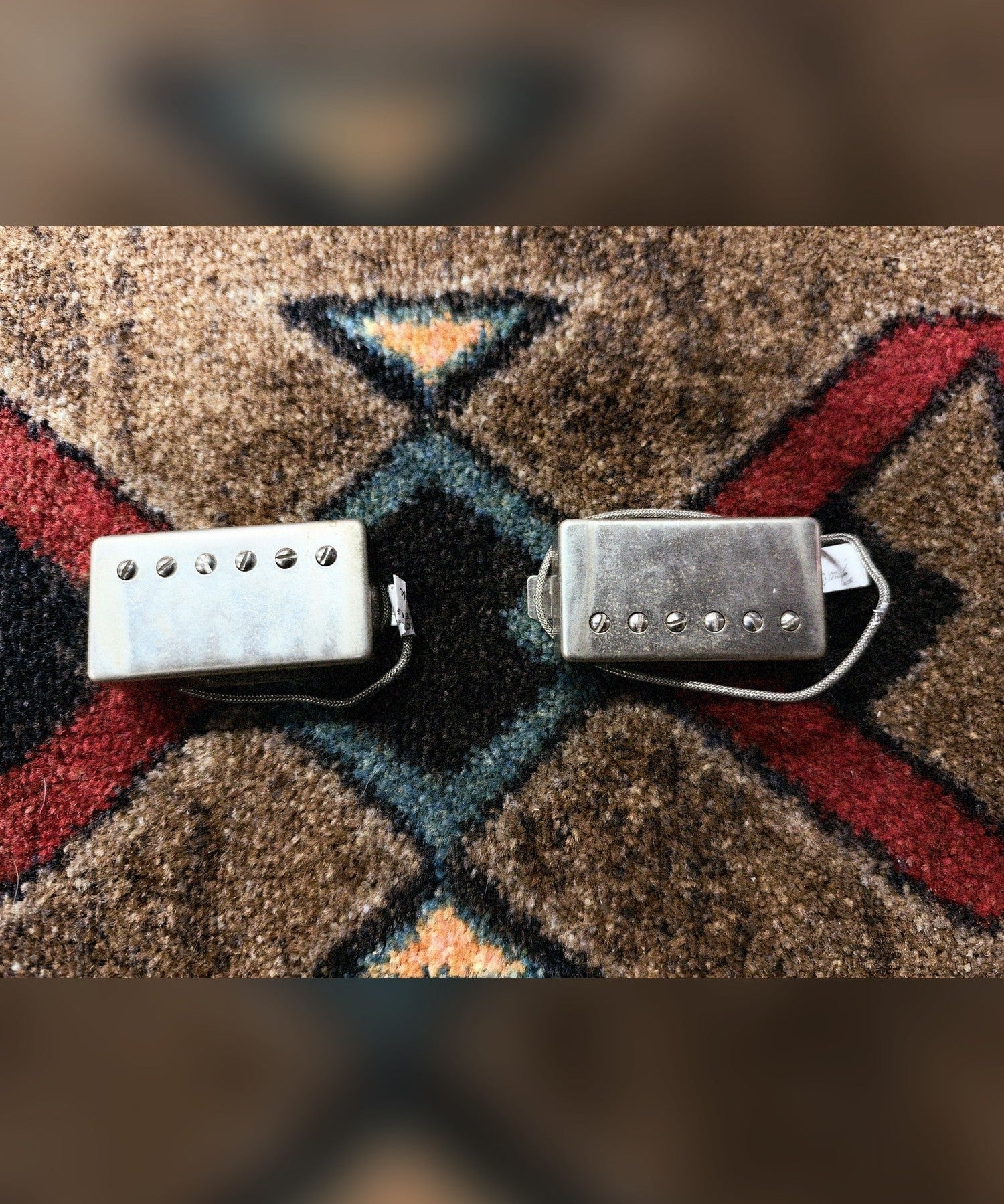 Lindy Fralin Modern P.A.F. humbucker set, nickel covers: both pickups face up with their braided leads and lead tags