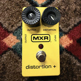 MXR M104 Distortion+, yellow: top with the Output and Distortion knobs, the MXR logo, the red LED and the footswitch