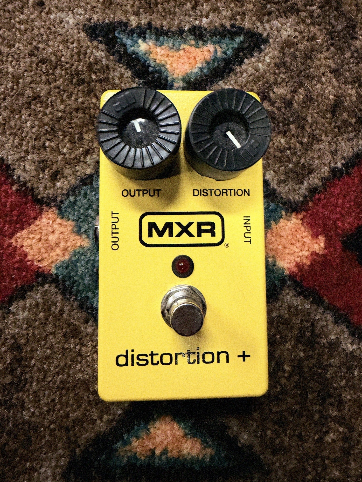 MXR M104 Distortion+, yellow: top with the Output and Distortion knobs, the MXR logo, the red LED and the footswitch