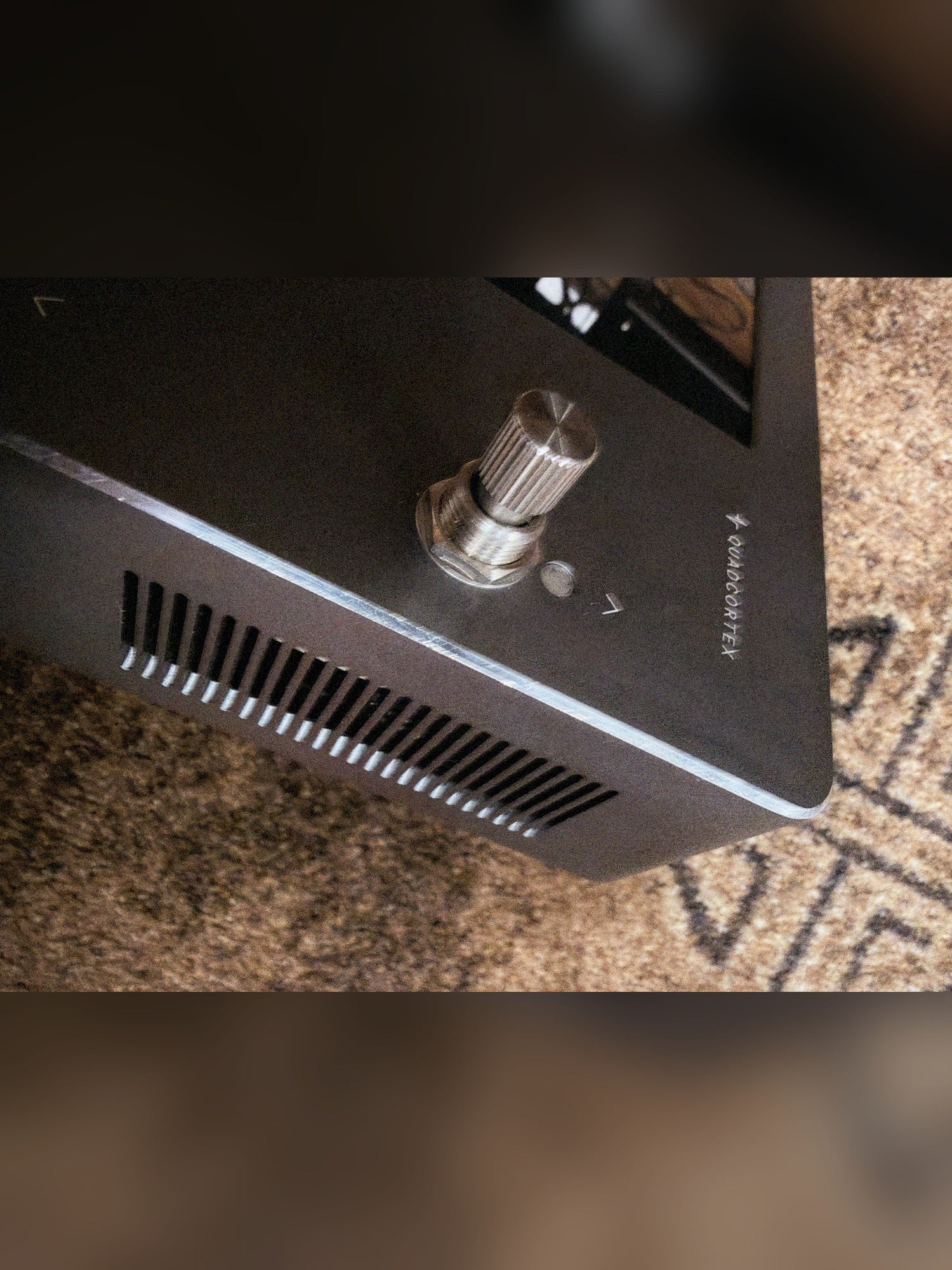 Neural DSP Quad Cortex, gray: side panel vents and the top-right footswitch
