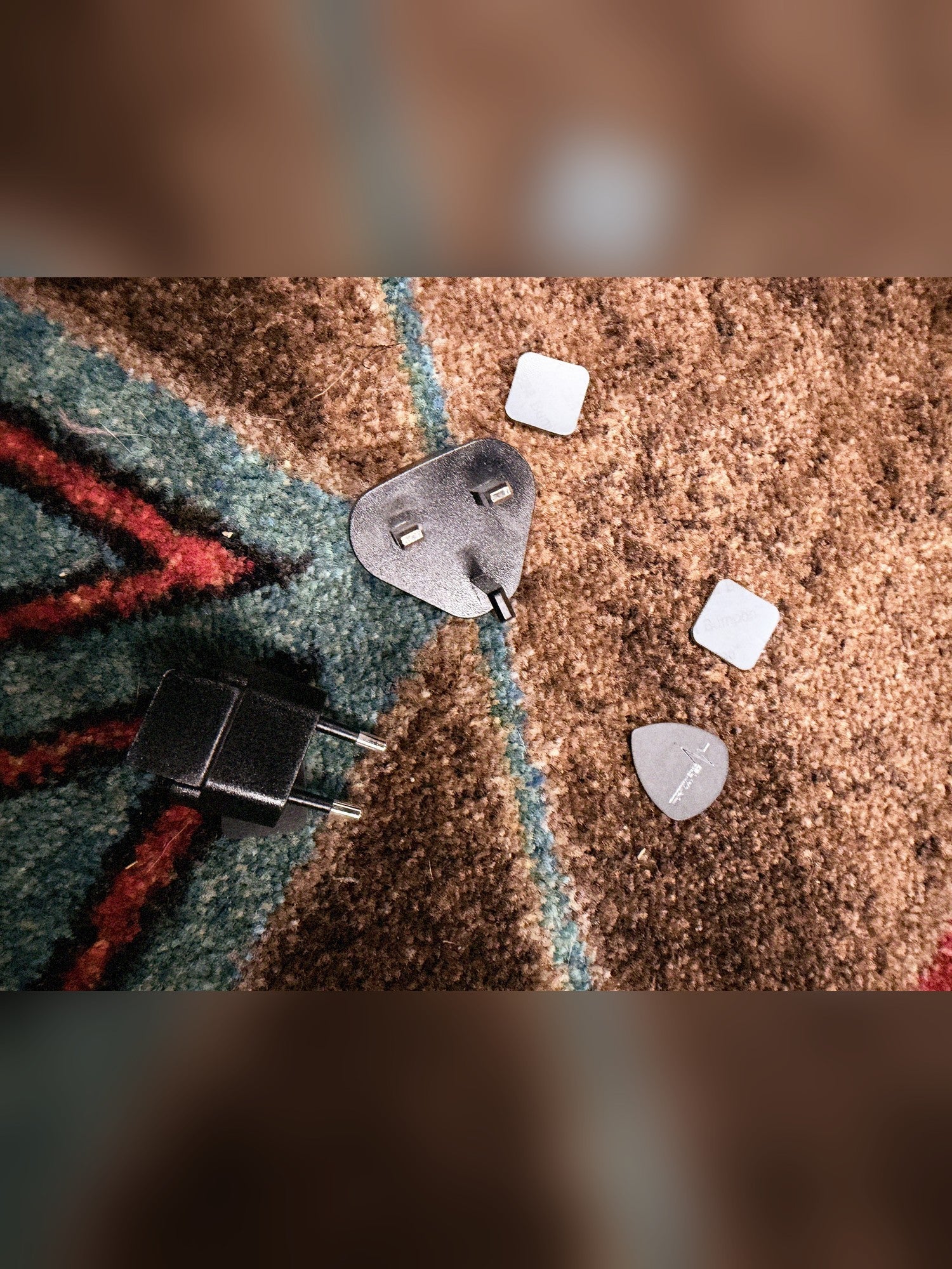 Neural DSP Quad Cortex, gray: UK and EU plug adapters, two stick-on rubber feet and a pick that come with it