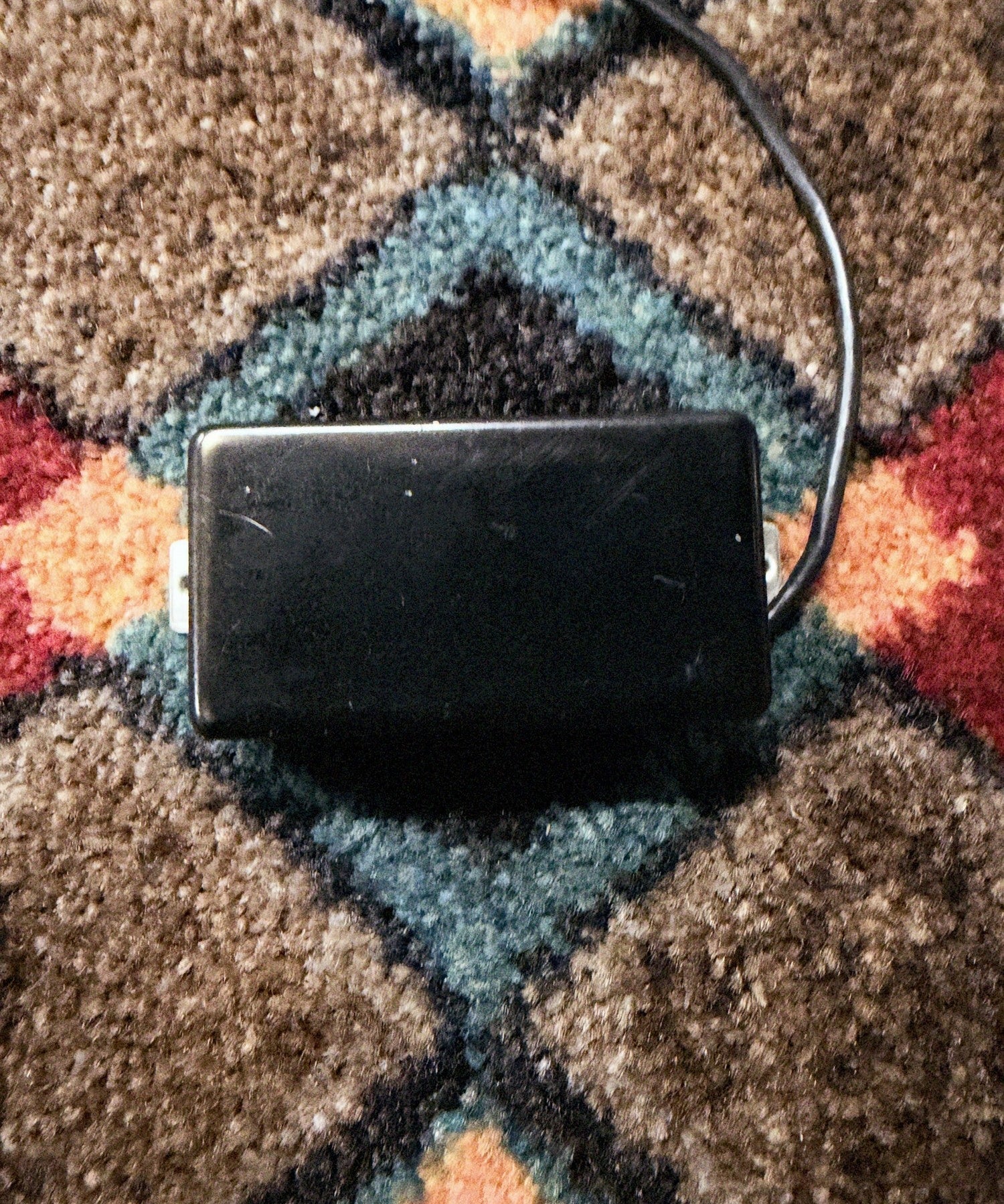 Porter Clear humbucker, bridge, black cover: front of the cover with no pole holes, with its lead