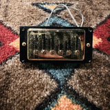 Seymour Duncan Antiquity Humbucker, aged gold: front of the bridge pickup in its black mounting ring, with the braided lead
