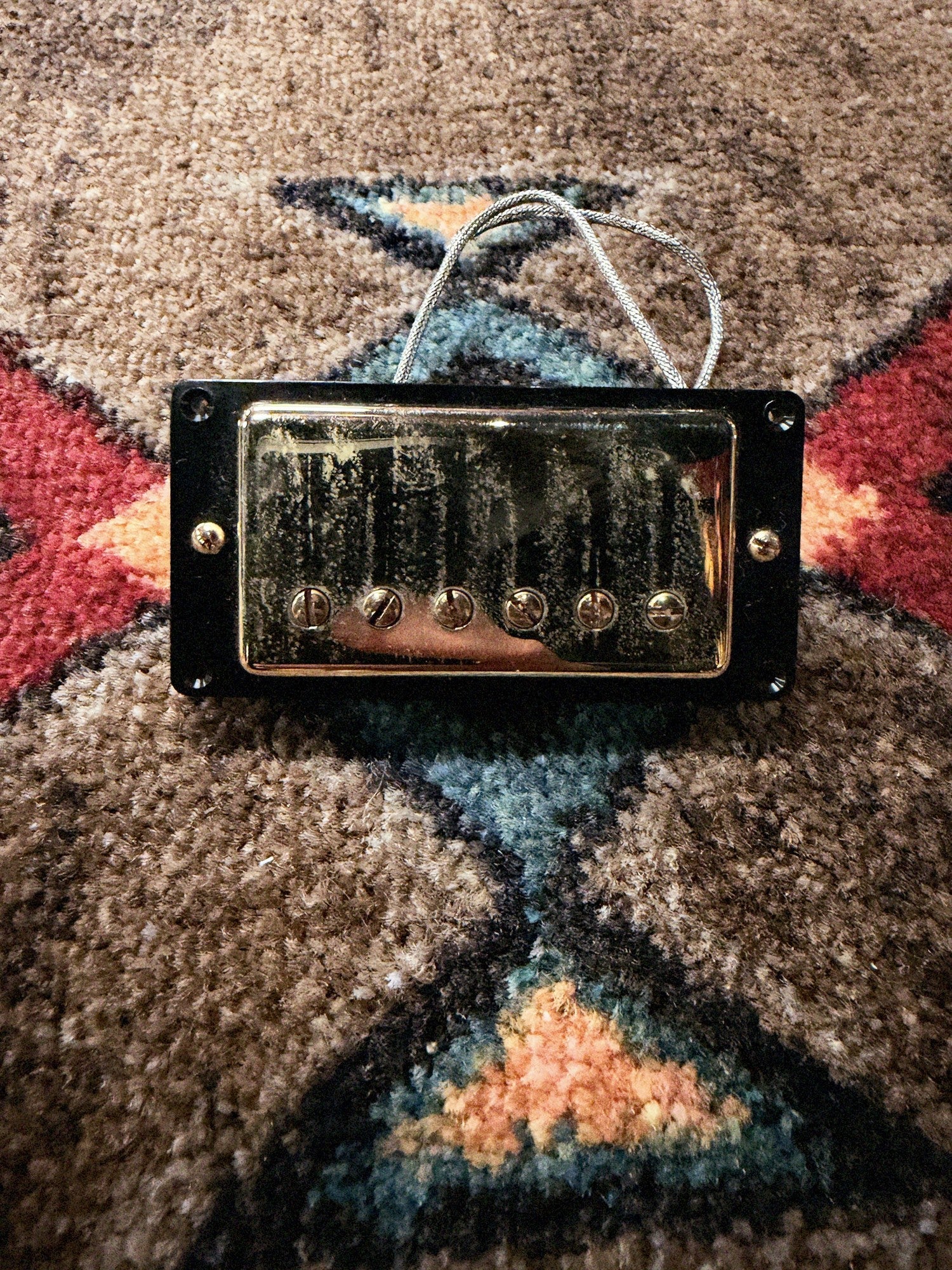 Seymour Duncan Antiquity Humbucker, aged gold: front of the bridge pickup in its black mounting ring, with the braided lead
