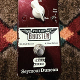Seymour Duncan Pickup Booster, dark red: top with the Gain knob, the Res Peak switch, the LED and the footswitch, with chips along the left edge